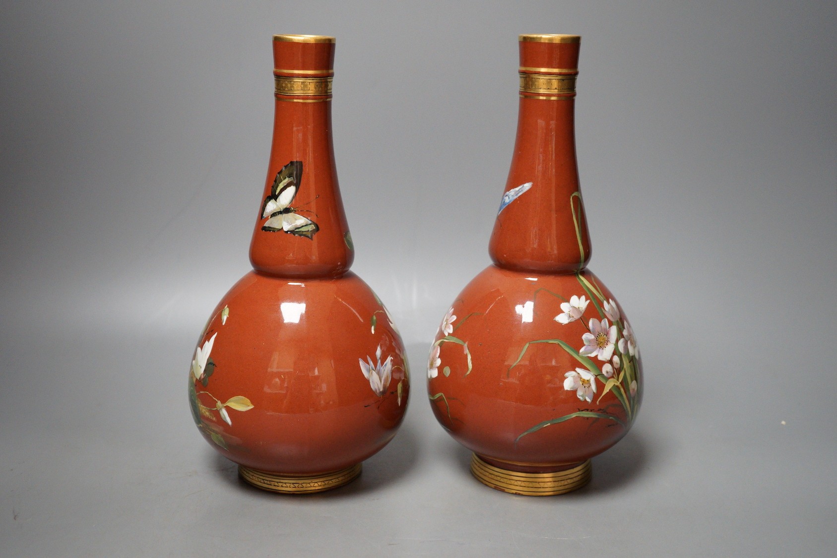 A pair of Mintons Aesthetic period enamelled pottery vases, c.1879, 26cm